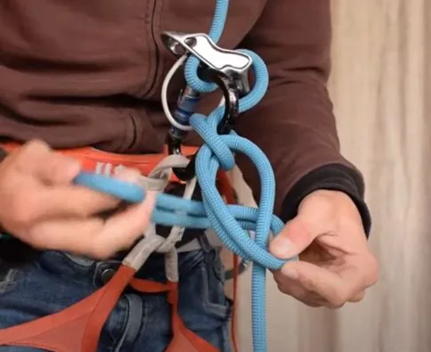 5. Puis après on fait un nœud d’arrêt, on fait le tour de la corde et on repasse dedans